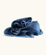 Dark blue 100% organic cotton play cloth ruffled up into a pile