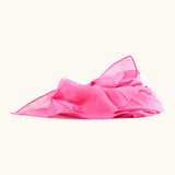 Bright pink 100% organic cotton play cloth ruffled up into a pile