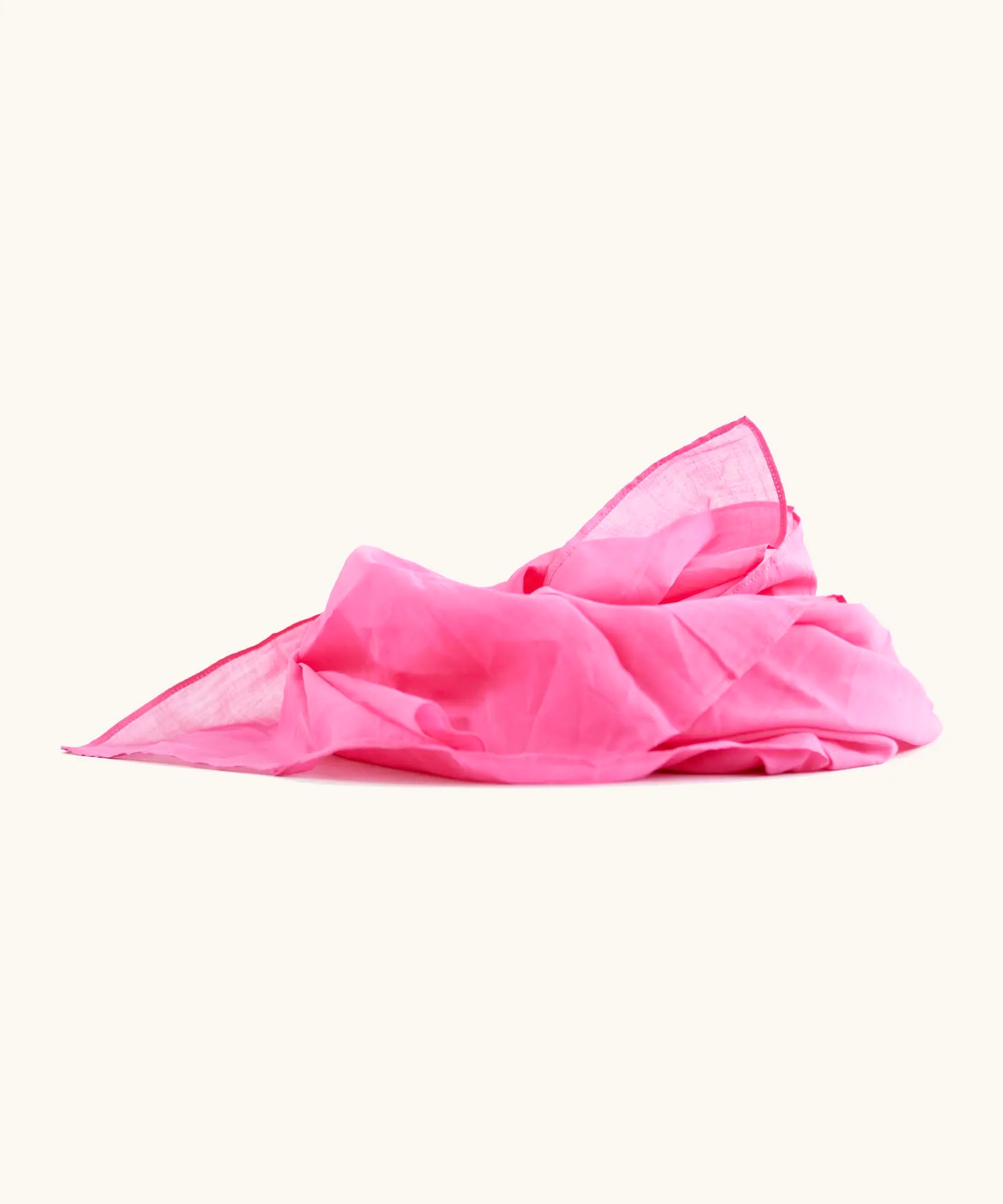 Bright pink 100% organic cotton play cloth ruffled up into a pile