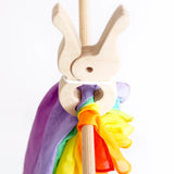 Laura's play cotton bright rainbow play cloth made from 100% organic cotton on a wooden rail and held by a wooden peg