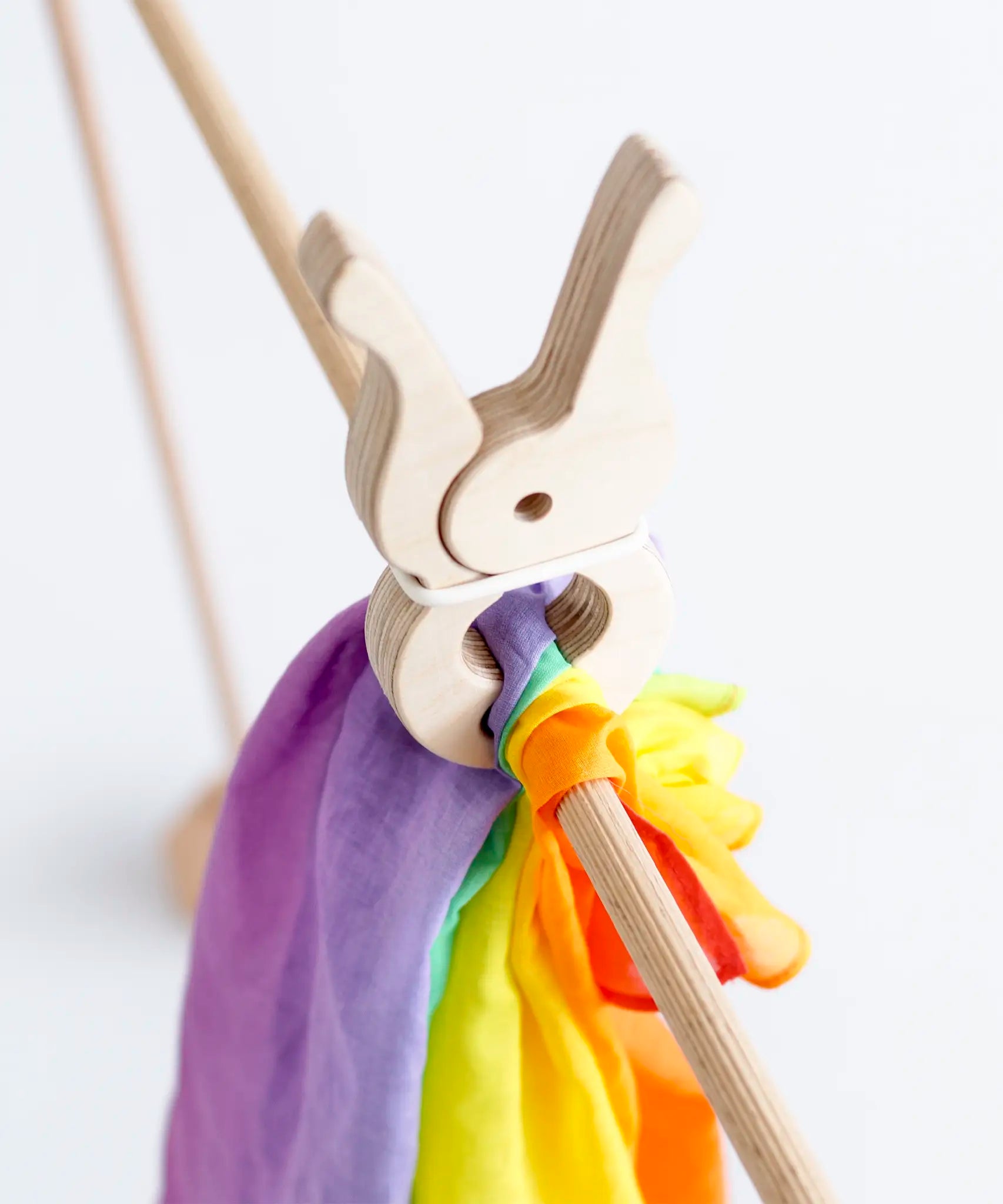 Laura's play cotton bright rainbow play cloth made from 100% organic cotton held by a wooden peg