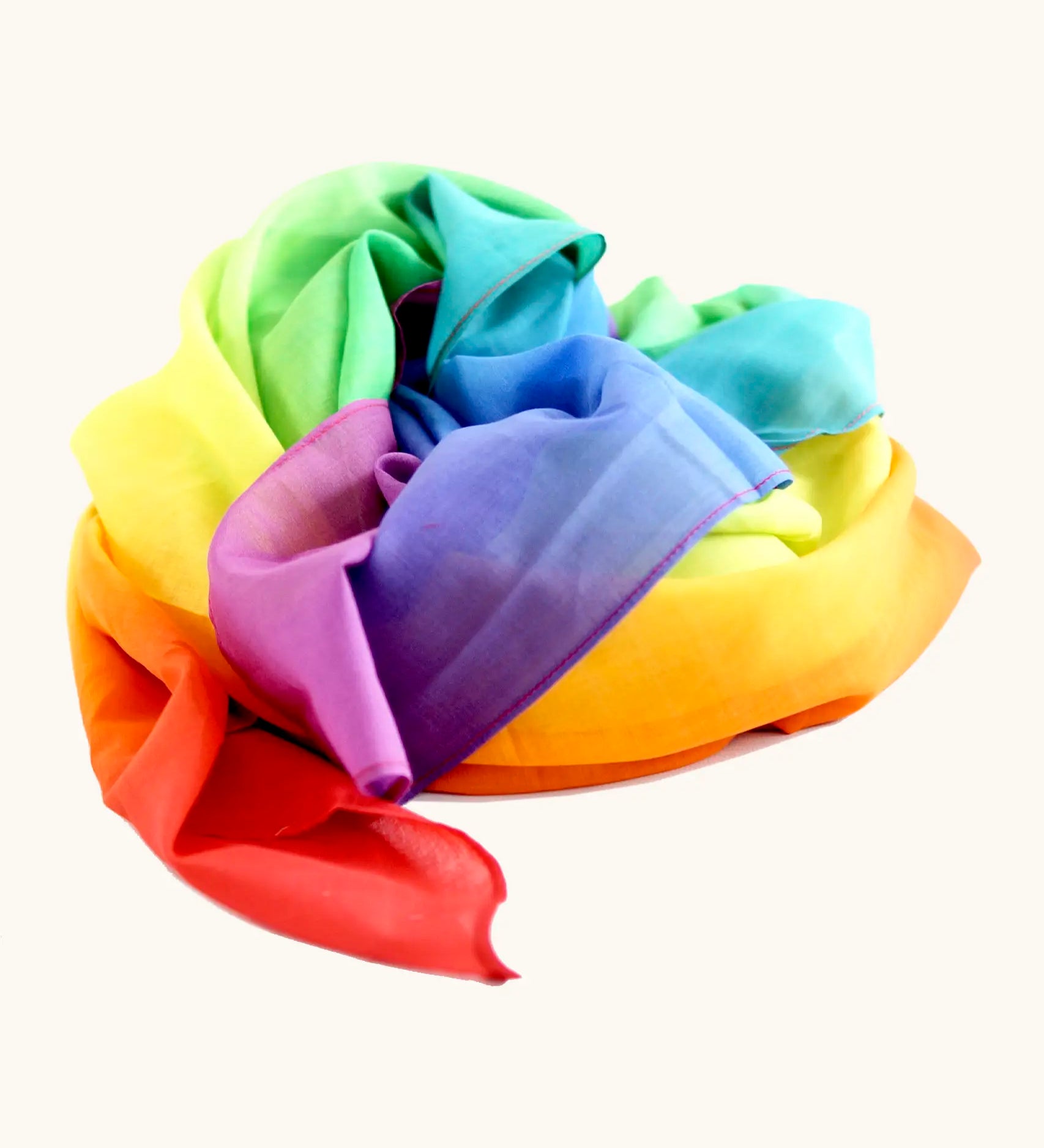 Laura's play cotton bright rainbow play cloth made from 100% organic cotton ruffled up into a pile