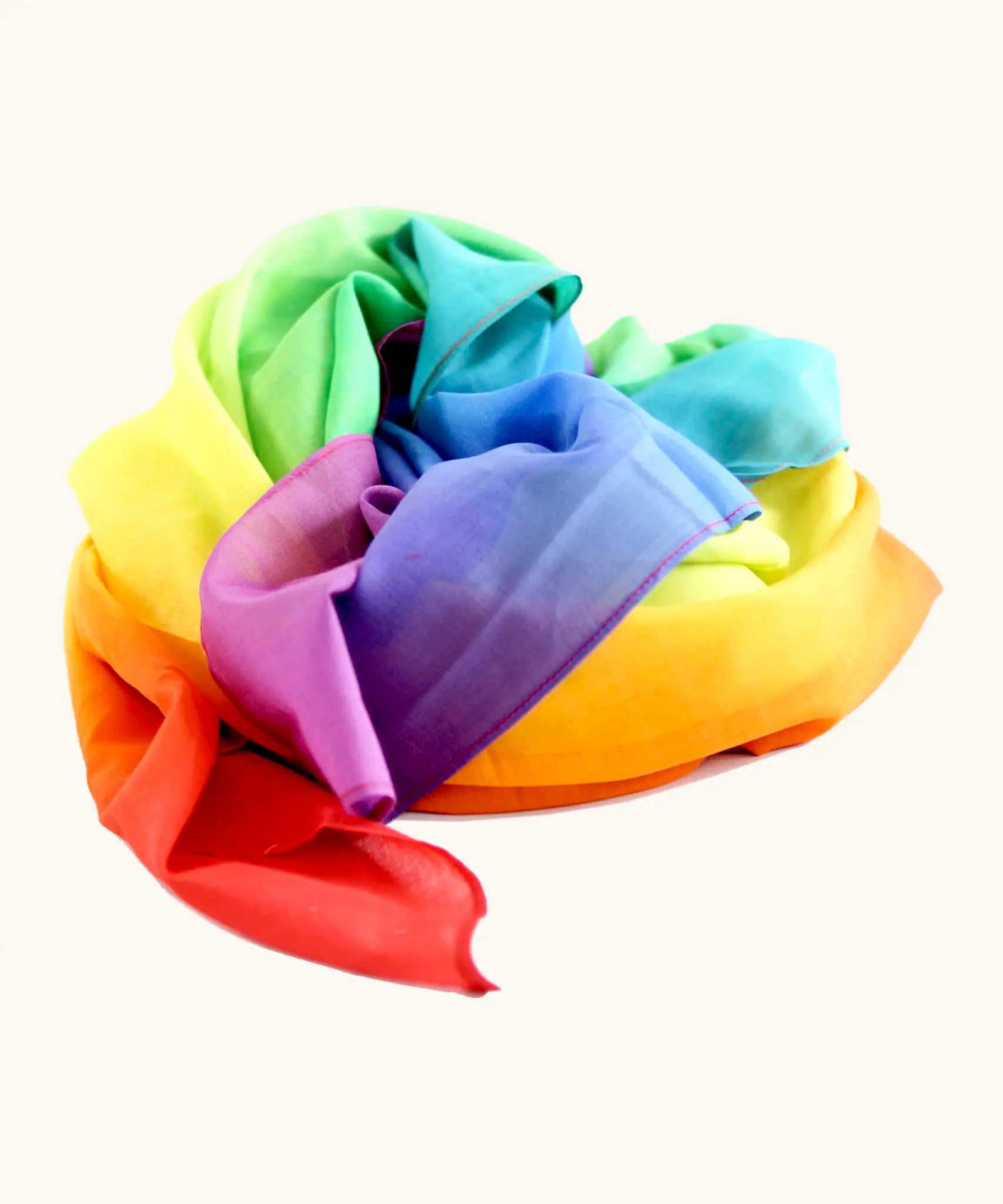 Laura's play cotton bright rainbow play cloth made from 100% organic cotton ruffled up into a pile