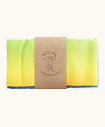 Laura's 100% organic cotton play cloth in a rainbow gradient held together by a decorated cardboard strip