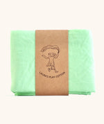 Laura's 100% organic cotton play cloth in light green held together by a decorated cardboard strip