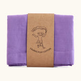 Laura's 100% organic cotton play cloth in violet held together by a decorated cardboard strip