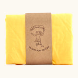 Laura's 100% organic cotton play cloth in yellow held together by a decorated cardboard strip