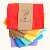 Pile of Laura's play cotton cloths in rainbow inspired colours. Made from 100% organic cotton 