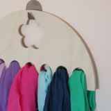A collection of Laura's 100%organic cotton play cloths on a wooden hanger 