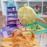 Laura's Play Cotton Play Cloths in yellow, green, purple and orange used in a small world play scene with Grimm's rainbow and building boards in the Babipur playroom.