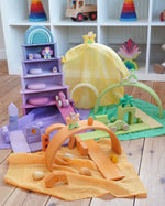 Laura's Play Cotton Play Cloths in yellow, green, purple and orange used in a small world play scene with Grimm's rainbow and building boards in the Babipur playroom.