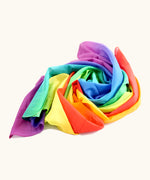 Laura's play cotton bright and pastel rainbow play cloths made from 100% organic cotton ruffled up into a pile