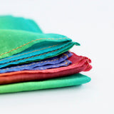 Laura's play cotton bright rainbow play cloth made from 100% organic cotton showing stitch detail on edge