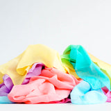 Laura's play cotton cloths in rainbow colours. Made from 100% organic cotton and ruffled up in a pile