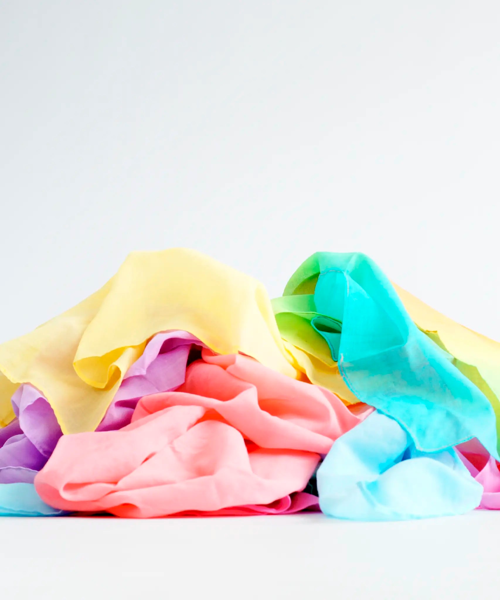 Laura's play cotton cloths in rainbow colours. Made from 100% organic cotton and ruffled up in a pile