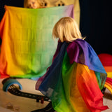 Children playing with Laura's play cotton rainbow cloths made from organic cotton in a playroom