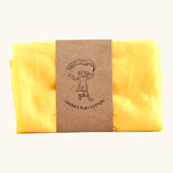 Laura's 100% organic cotton small play cloth in yellow held together by a decorated cardboard strip