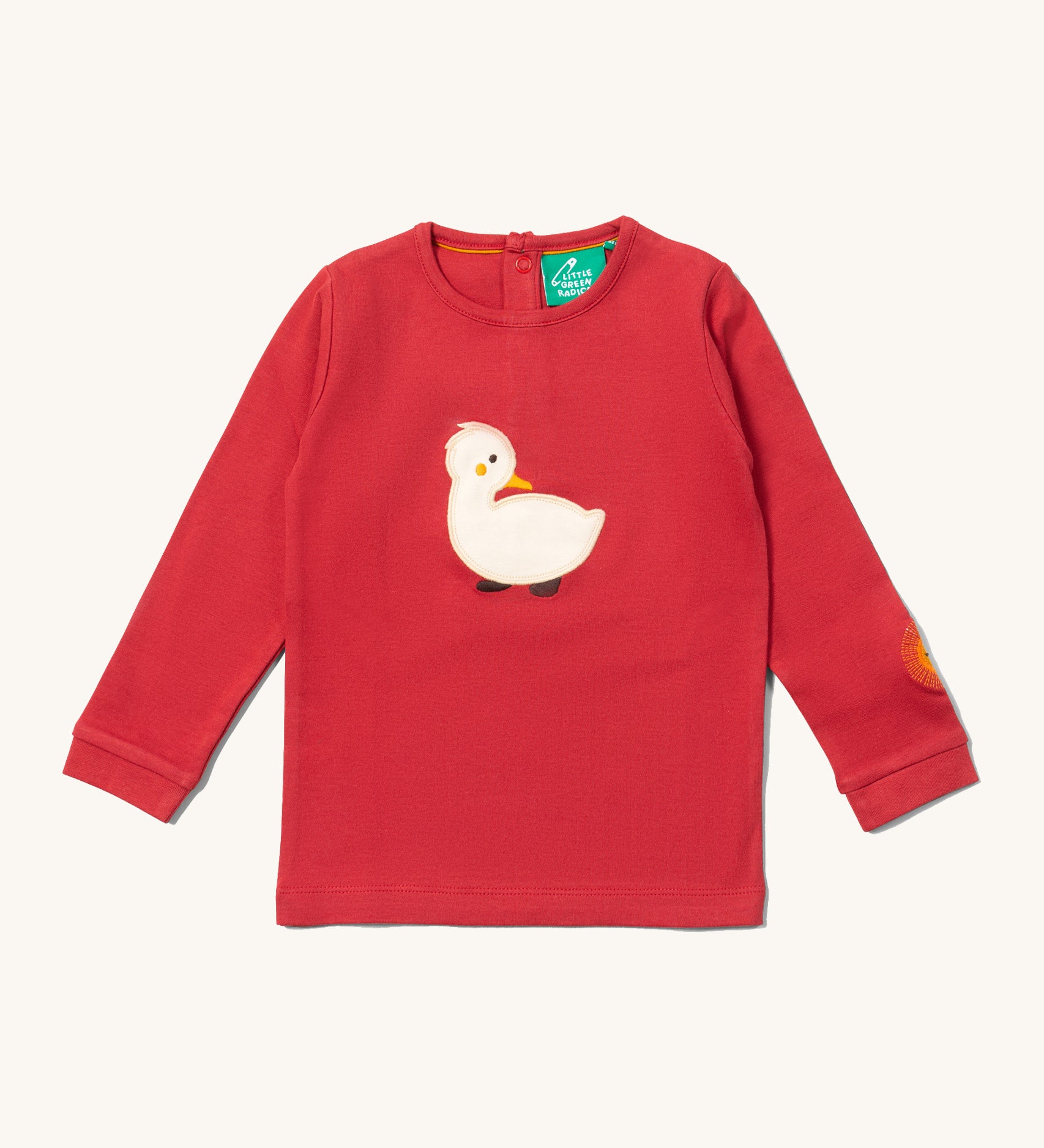 Little Green Radicals kids top available at Babipur. A GOTS organic cotton long sleeved top in red with a white duckling applique on the front and a sun embroidery on the sleeve. Features poppers on the back.