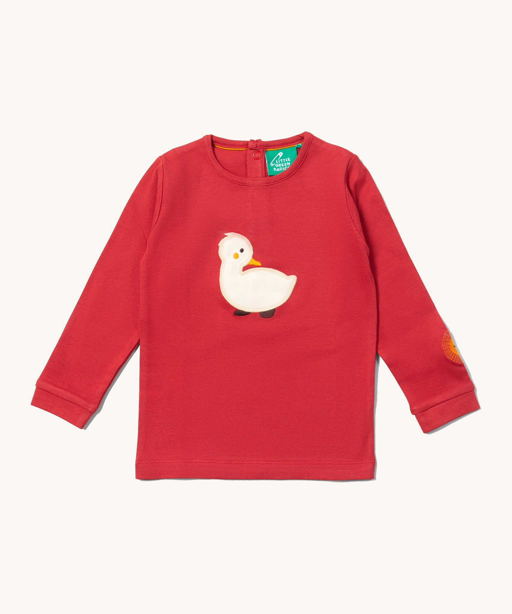 Little Green Radicals kids top available at Babipur. A GOTS organic cotton long sleeved top in red with a white duckling applique on the front and a sun embroidery on the sleeve. Features poppers on the back.