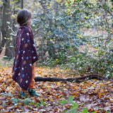 A brown flying birds patterned knitted baby blanket by Little Green Radicals — made with Fairtrade and GOTS-certified organic cotton — keeps a child warm in the forest, offered at Babipur.
