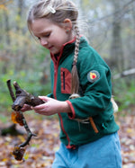 Girl running around a forest wearing Polar Fleece Jacket in Olive green by Little Green Radicals, made from recycled fleece, available now at Babipur.