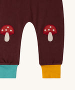 A close up of the Little Green Radicals knee patch joggers in toadstool design showing the toadstool knee patch detail