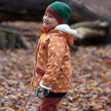 Child in a forest wearing Knit Beanie in chive green with a crimson trim by Little Green Radicals - made from soft GOTS organic and Fairtrade certified cotton - shop now at Babipur. 