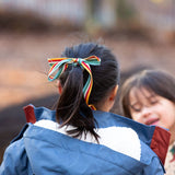 Close up of the back of a child outdoor wearing a Kids Warm Waterproof, 5000MM rating, PFC Free, Winter Hooded School Coat in Moonlight Blue print, with a cosy and fluffy lined hood, by Little Green Radicals, made from recycled bottles and a cosy polyester fleece, buy now at Babipur.

