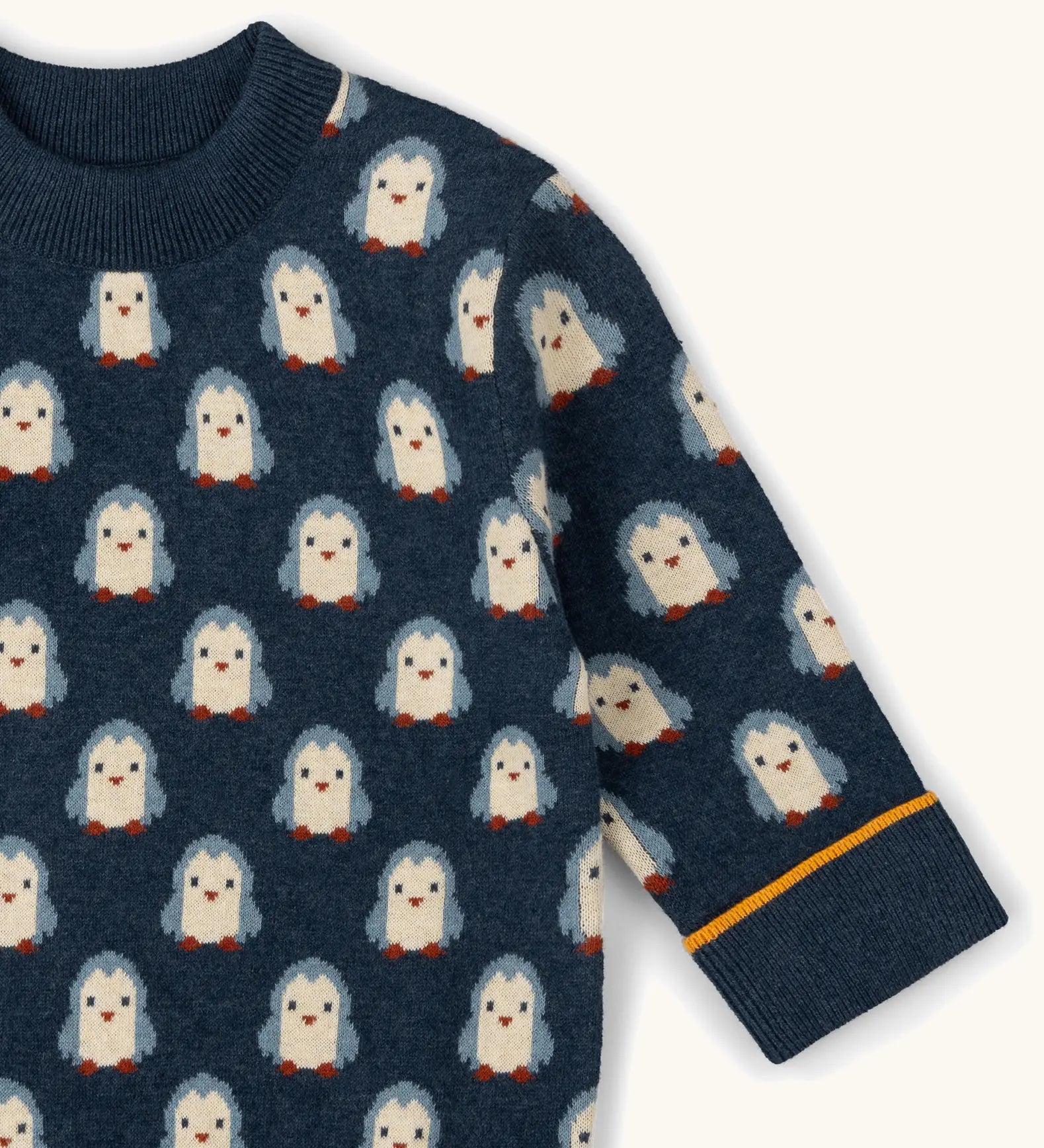 Little Green Radicals Knitted Jumper in Blue with penguin design with yellow stripe on cuff, made from Fairtrade certified cotton.