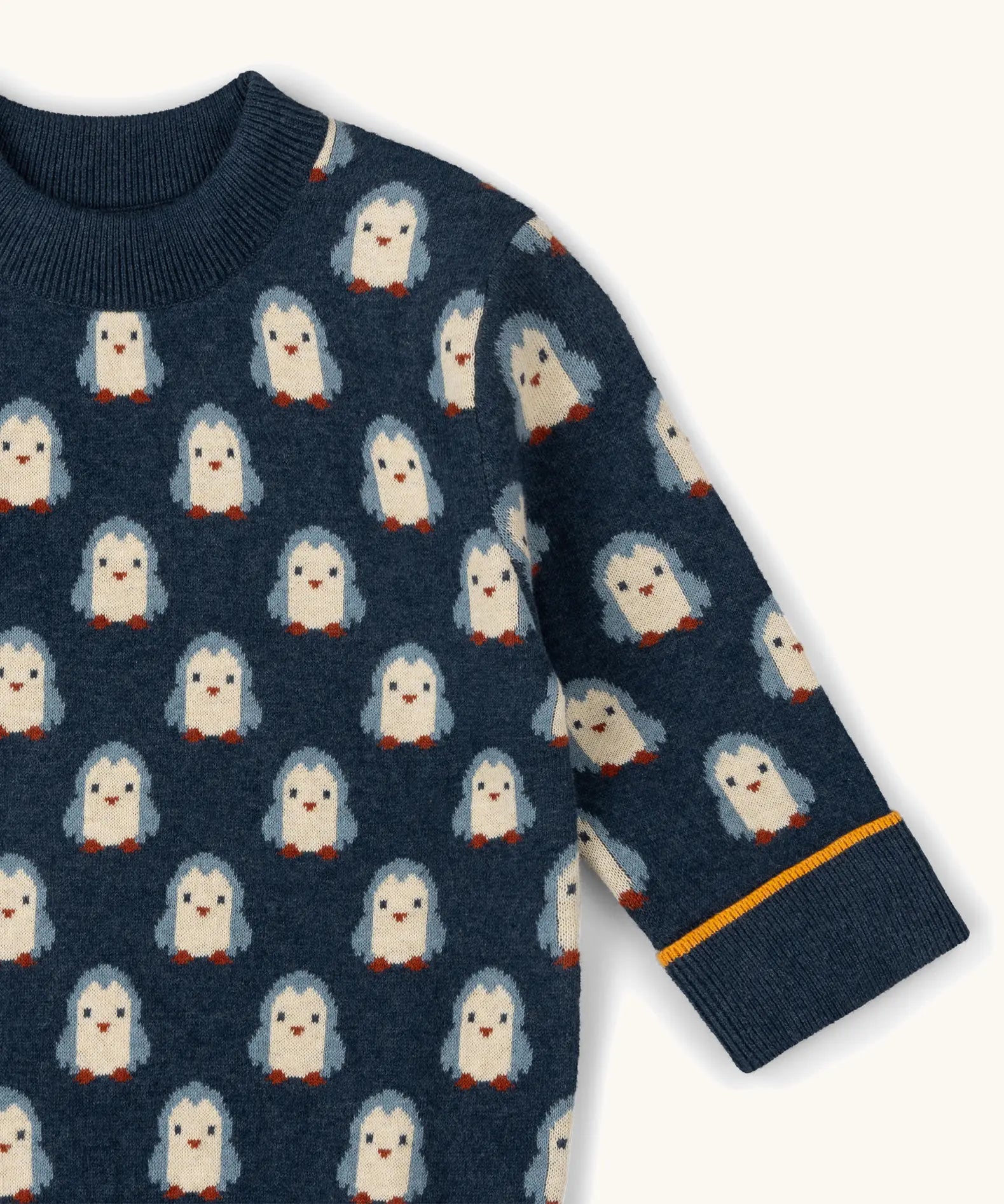 Little Green Radicals Knitted Jumper in Blue with penguin design with yellow stripe on cuff, made from Fairtrade certified cotton.