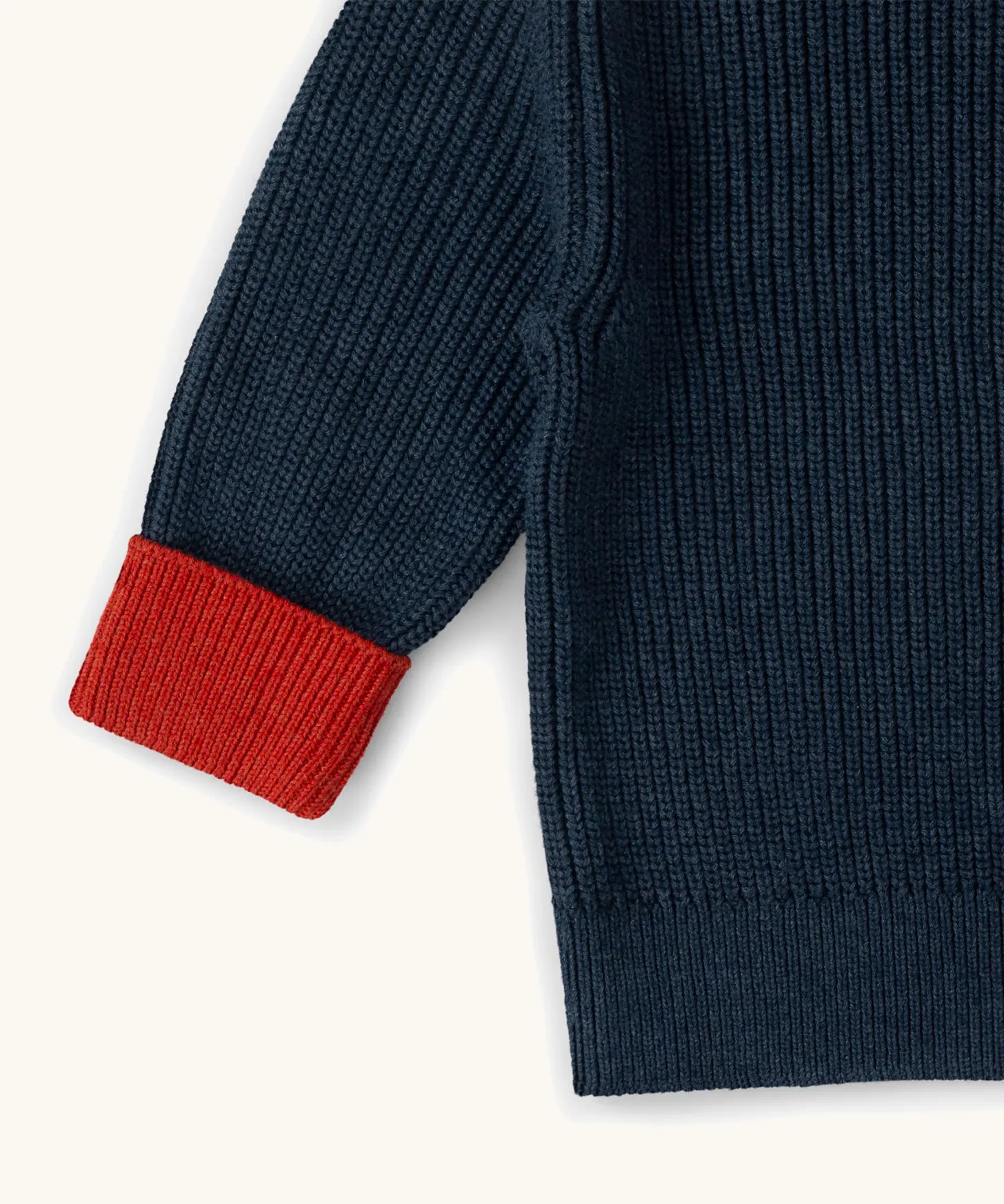 Little Green Radicals Knitted Snuggly Jumper in Midnight Blue with red cuffs, made from GOTS organic cotton.