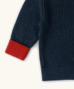 Little Green Radicals Knitted Snuggly Jumper in Midnight Blue with red cuffs, made from GOTS organic cotton.