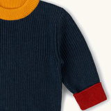 Little Green Radicals Knitted Snuggly Jumper in Midnight Blue, a chunky knit, made from Fairtrade cotton with a yellow collar and red cuffs.