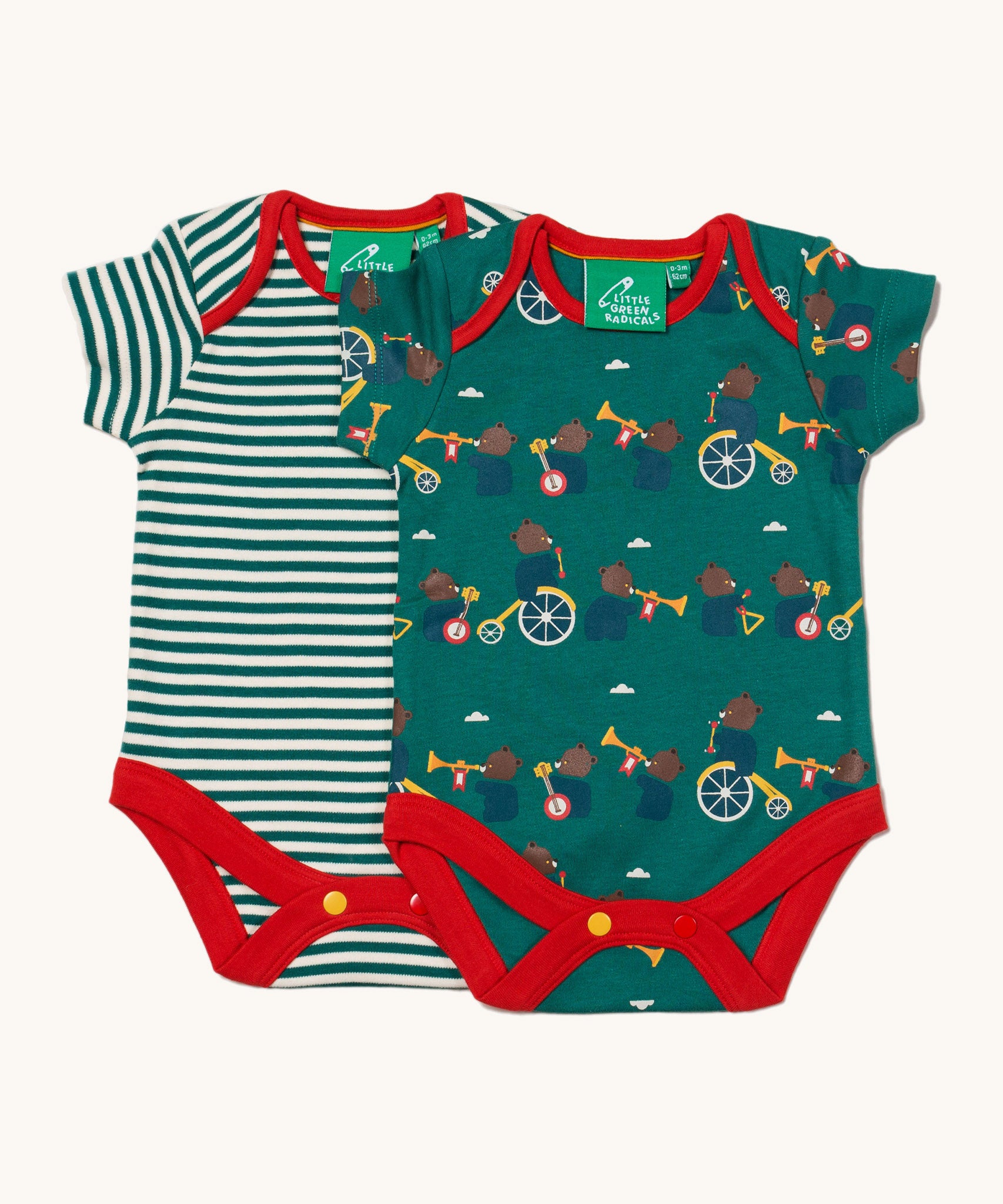 A 2 pack of Little Green Radicals The Bear Jamboree Baby Body Set. One vest has a green and white stripe with the other vest featuring an all over  print of bears playing instruments. These short sleeved baby best are part of a wide range of organic cotton baby clothes available at Babipur. 