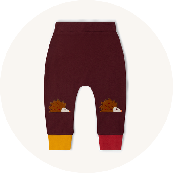 Little Green Radicals organic cotton trousers with hedgehog knee patches and yellow and red cuffs to represent Little Green Radicals trousers at Babipur.