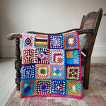 MADE51 Habibi Small Handmade Crochet Blanket draped over a wooden chair