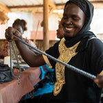 A bead crafting artisan refugee creating a beautiful bead necklace