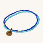 MADE51 Handmade #WithRefugees Bracelet in light and dark blue, and a brass coloured metal MADE51 tag