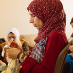 A Syrian refugee creating a beautiful blanket made in partnership with Oshana and MADE51