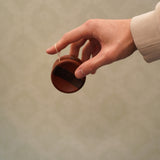 An adult hand about to throw the Mader free wheel butterfly traditional yoyo available at Babipur 