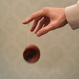 An adult playing with the Mader free wheel butterfly yoyo available at Babipur. 