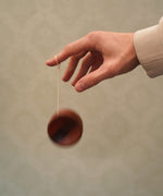 An adult playing with the Mader free wheel butterfly yoyo available at Babipur. 