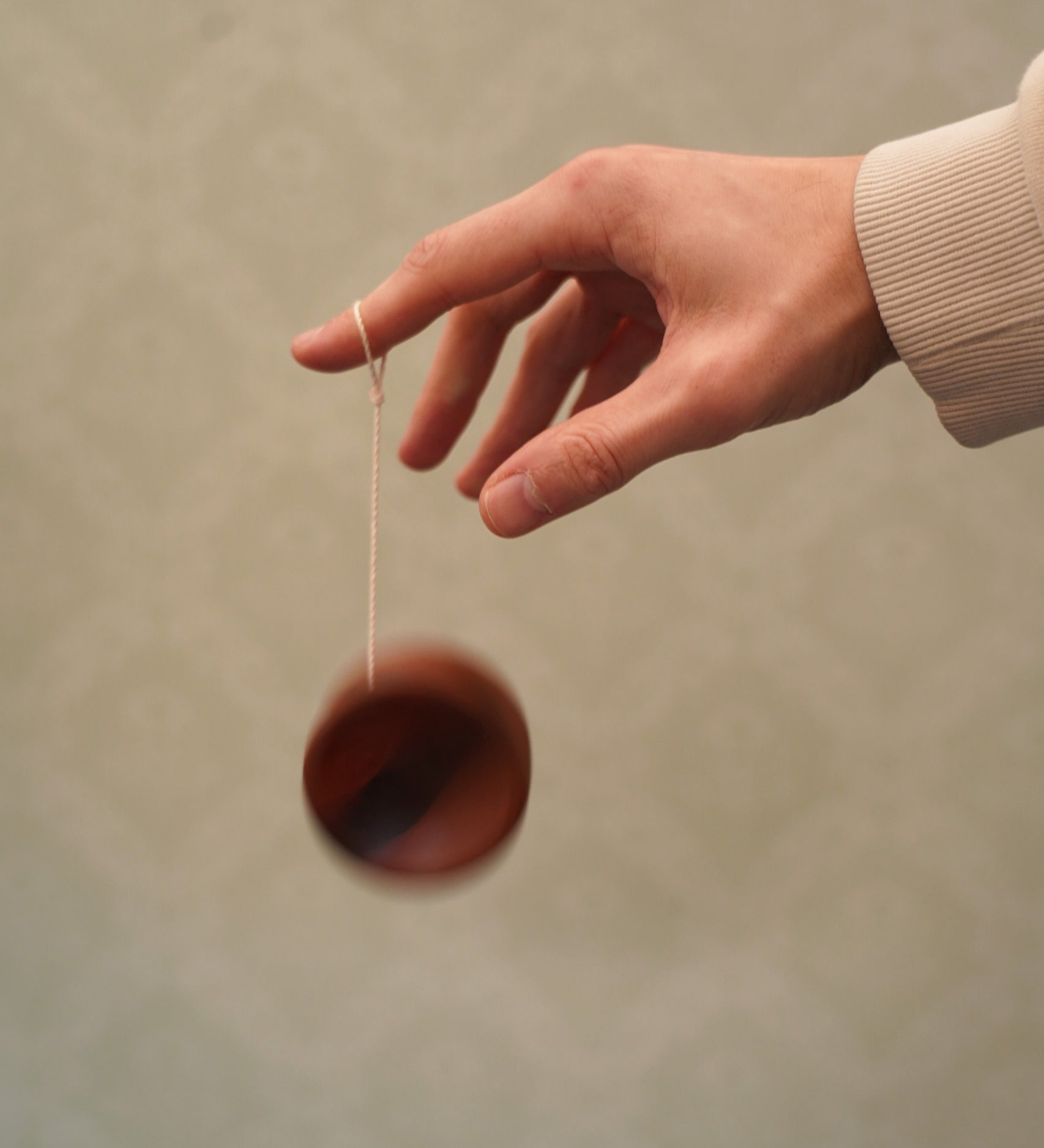 An adult playing with the Mader free wheel butterfly yoyo available at Babipur. 