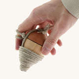 an adult hand holding the Mader natural profi throw wooden spinning top available at Babipur showing scale