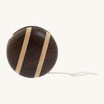 A natural freehweel wooden Mader yo yo with natural string and different woods, showcasing the unique grains and colours of the natural wood on a cream background.