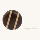 A natural freehweel wooden Mader yo yo with natural string and different woods, showcasing the unique grains and colours of the natural wood on a cream background.
