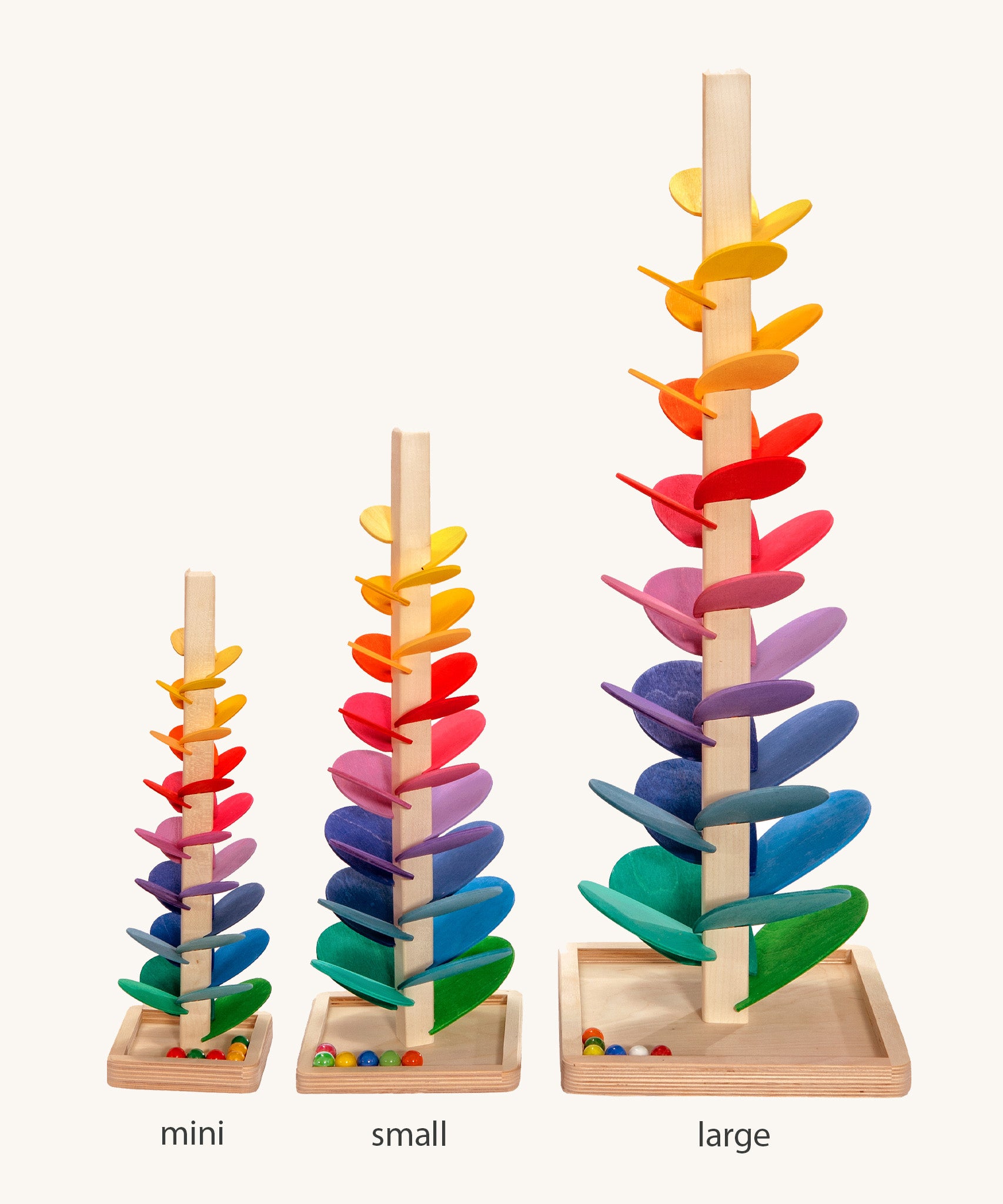 Comparison of Magic Wood Marble trees: mini, small and large. Satisfying wooden marble runs made of a tall stem, rainbow leaves and marbles.