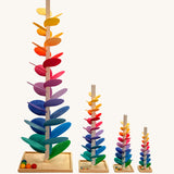 Comparison of Magic Wood Marble trees: mini, small, large and giant. Satisfying wooden marble runs made of a tall stem, rainbow leaves and marbles.