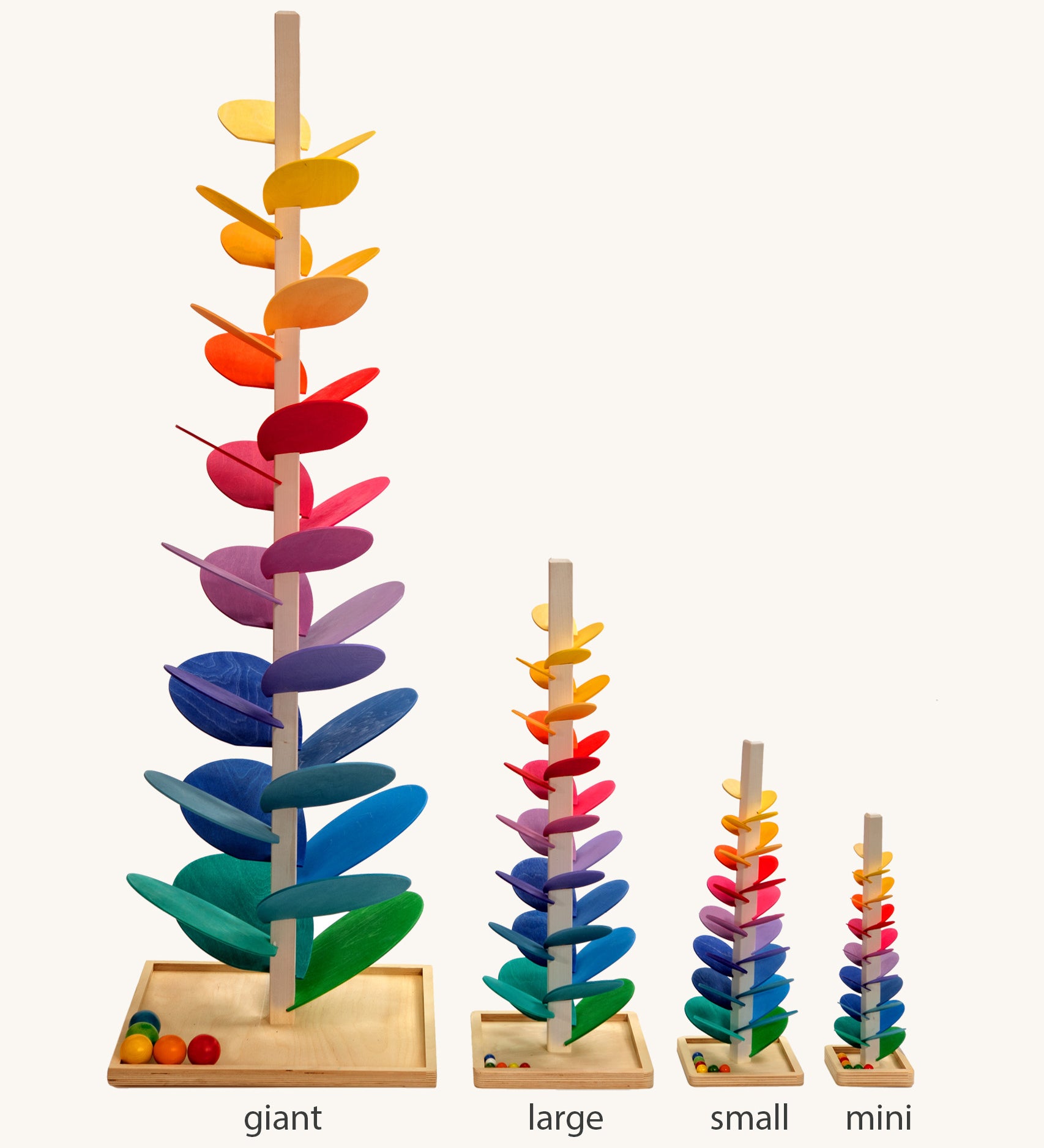 Comparison of Magic Wood Marble trees: mini, small, large and giant. Satisfying wooden marble runs made of a tall stem, rainbow leaves and marbles.