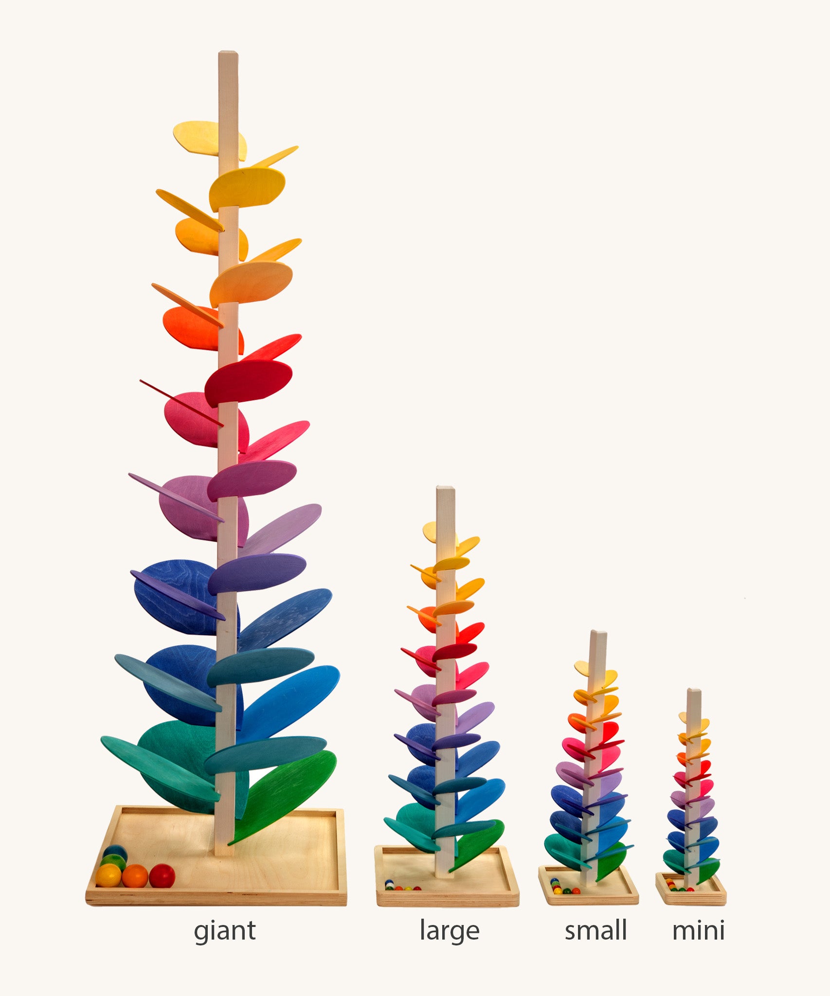 Comparison of Magic Wood Marble trees: mini, small, large and giant. Satisfying wooden marble runs made of a tall stem, rainbow leaves and marbles.